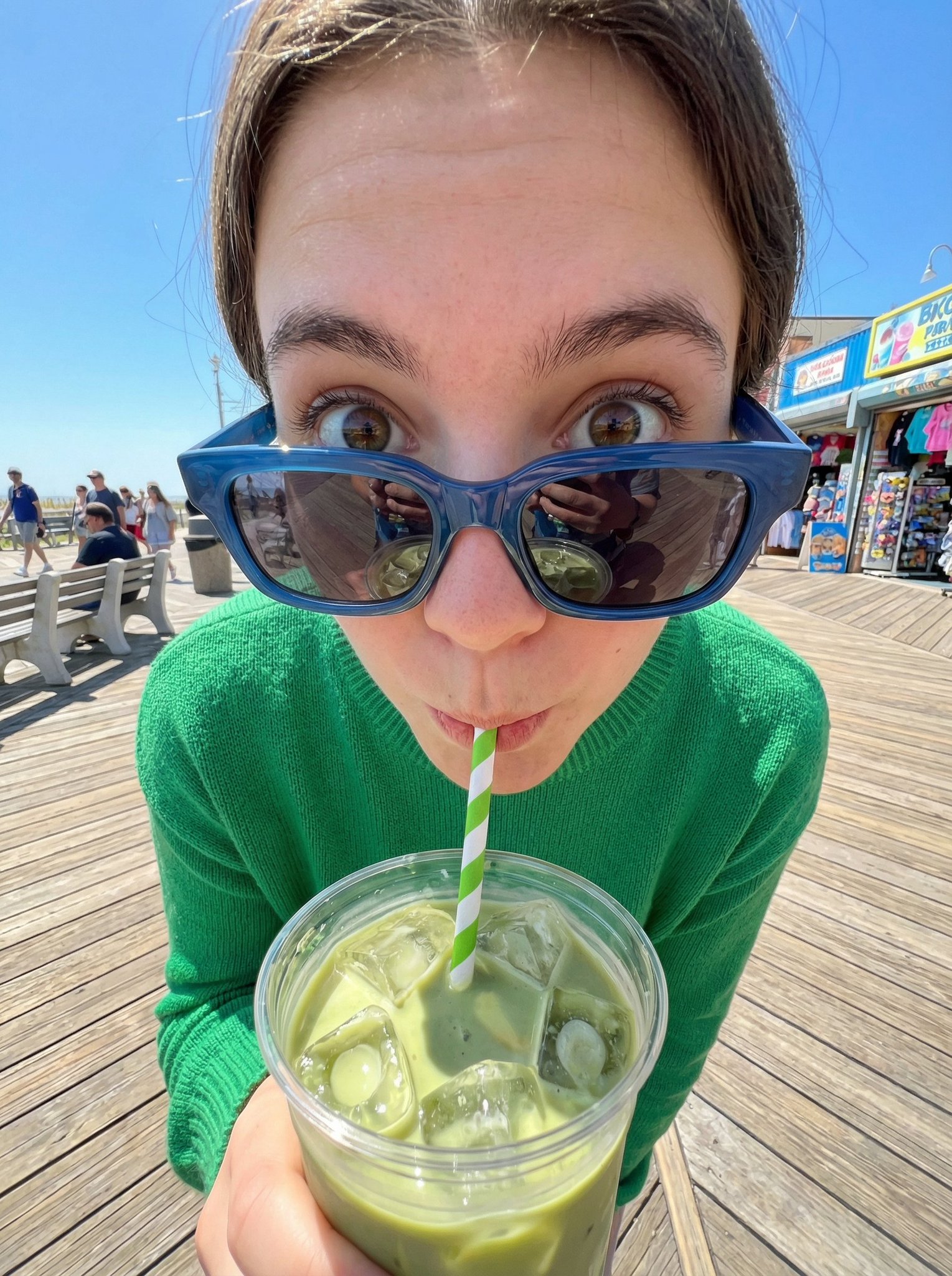 Matcha Girl Sipping Iced Latte on Sunny Boardwalk